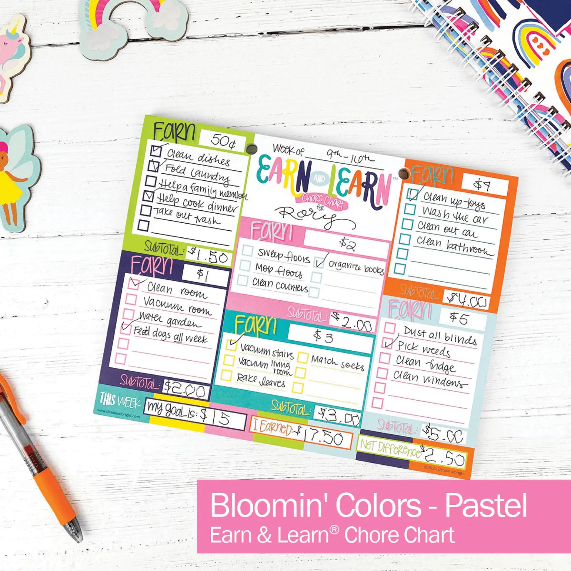 Colorful chore chart with a pen on a white wooden surface, featuring 'Bloomin' Colors - Pastel' branding.