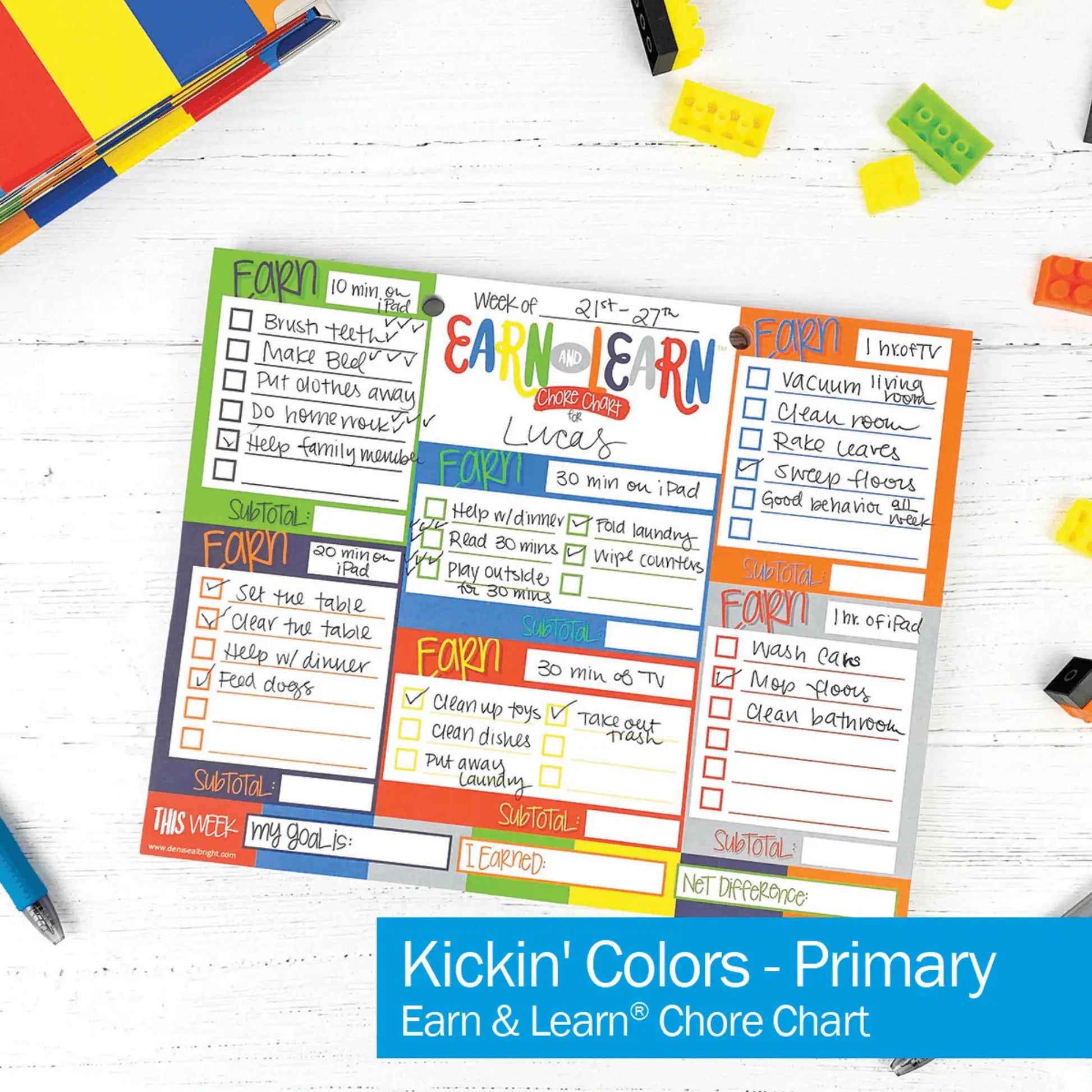 Colorful chore chart for children on a white surface with educational toys.